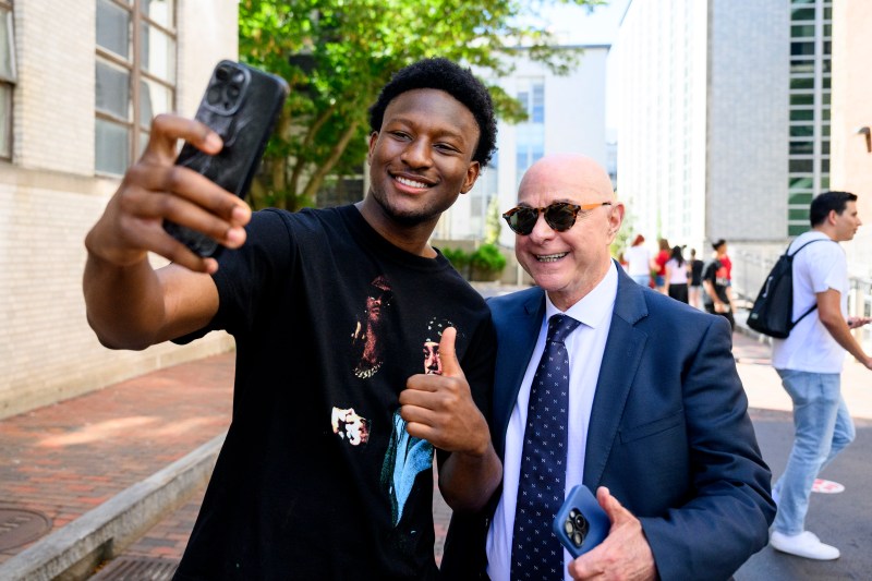 A student and President Aoun pose for a selfie.