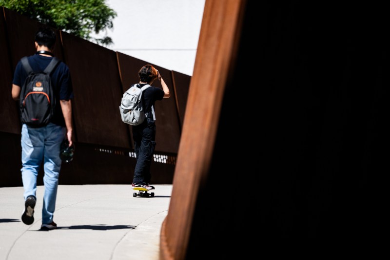 Students walk over a bridge.