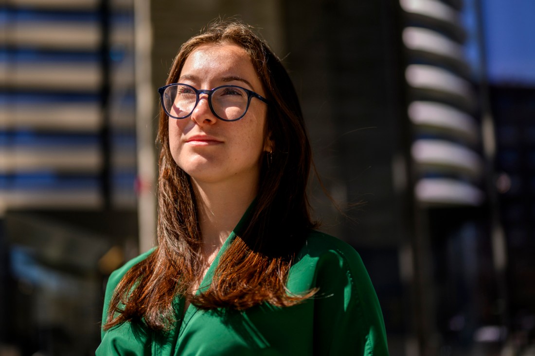 Federica Ciummo, a young female student with glasses, looks off into the distance with daylight illuminating her face.