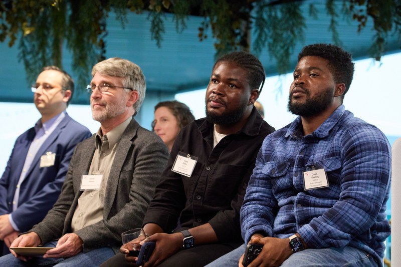Rows of audience members sitting at the Roux Institute listening at an event.