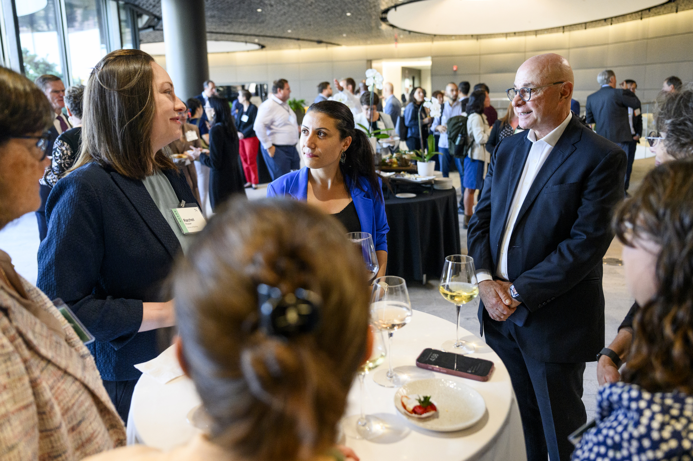 President Joseph E. Aoun shown in conversation with several new faculty members atop the EXP building on the Boston campus.