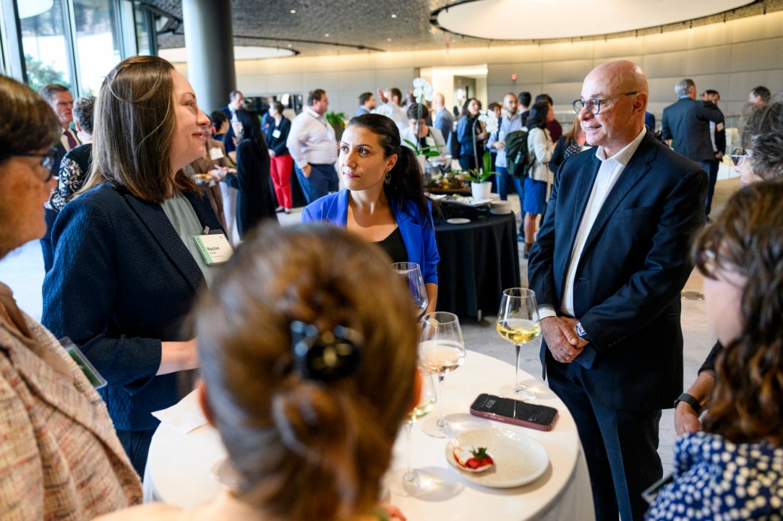 President Joseph E. Aoun shown in conversation with several new faculty members atop the EXP building on the Boston campus.