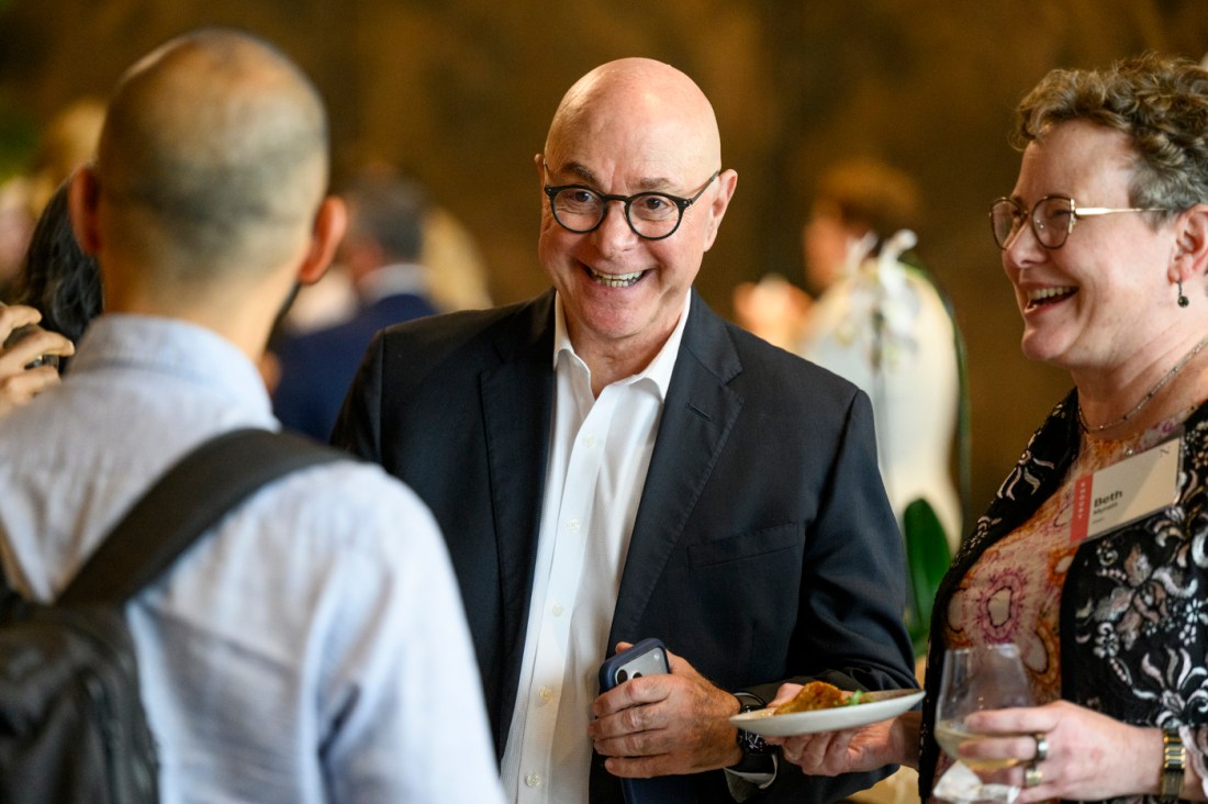 President Aoun smiling and laughing with guests.