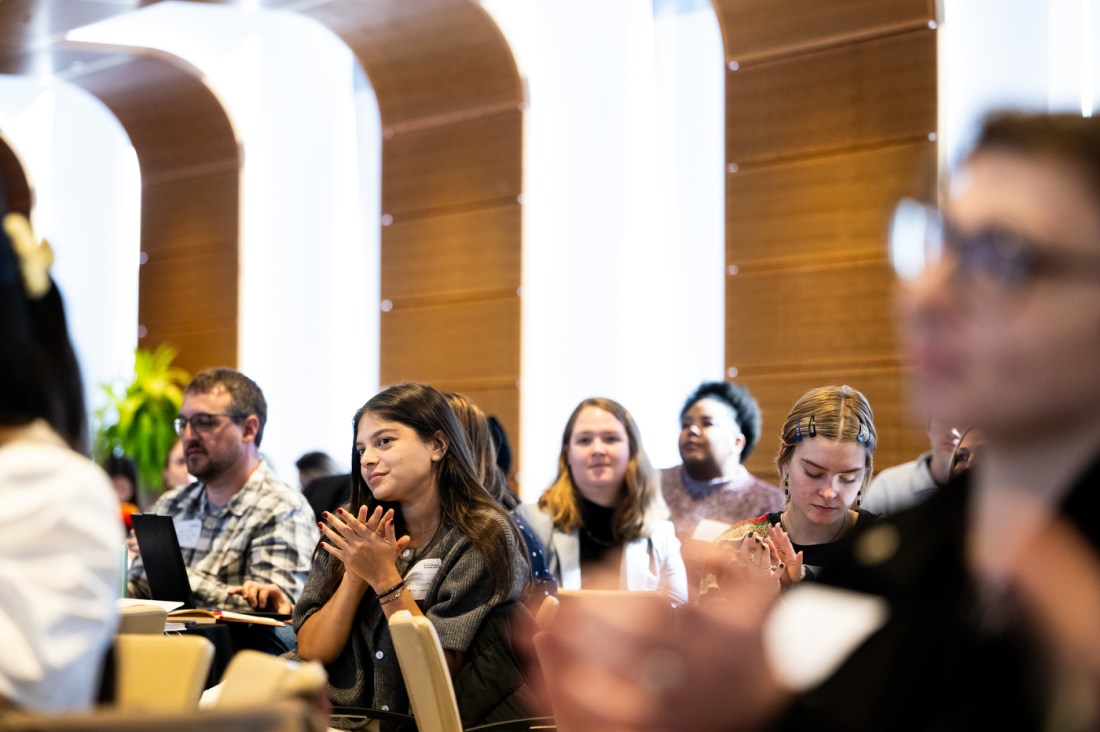 Attendees of the Northeastern Social Media Summit clap for a presenter. 