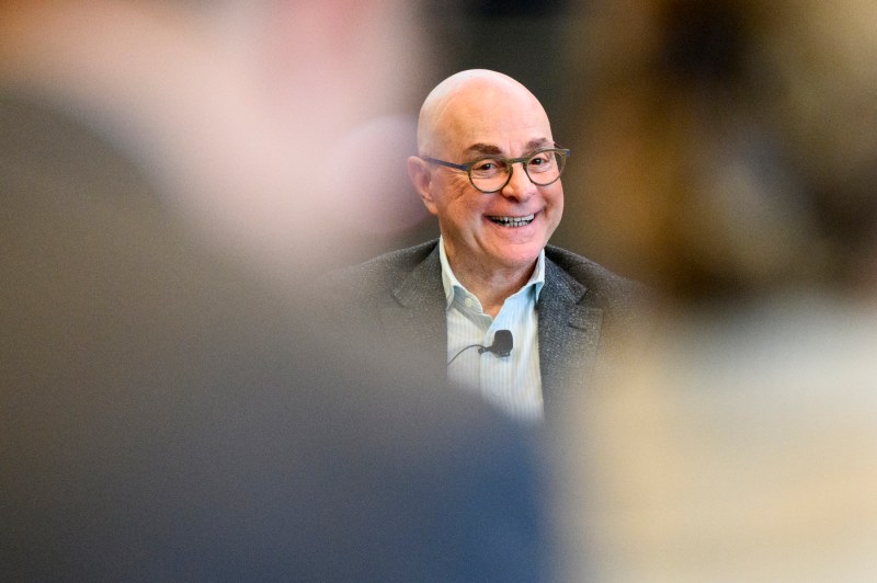 Joseph E. Aoun smiles warmly while addressing an audience during a campus discussion event.