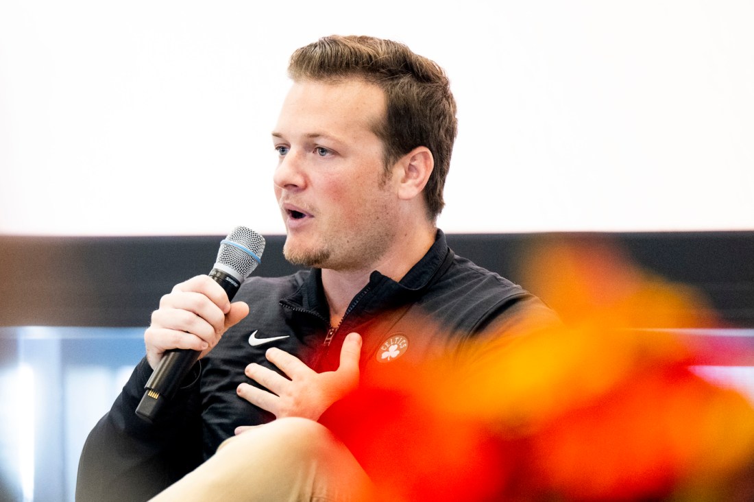 Mike Sivo speaks into a microphone during a panel at the Social Media Summit. 