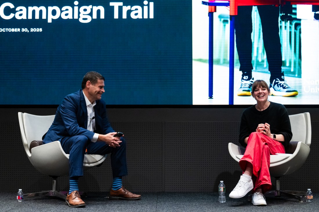 Dan Urman and Amanda Litman sit on stage smiling during a discussion at the Civic Experience: From the Classroom to the Campaign Trail event at Northeastern University.