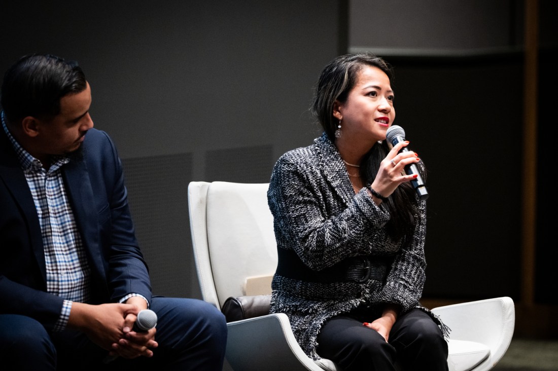 Massachusetts legislator Tram Nguyen speaks during the Civic Experience panel discussion at Northeastern University as fellow panelist Manny Cruz listens beside her.