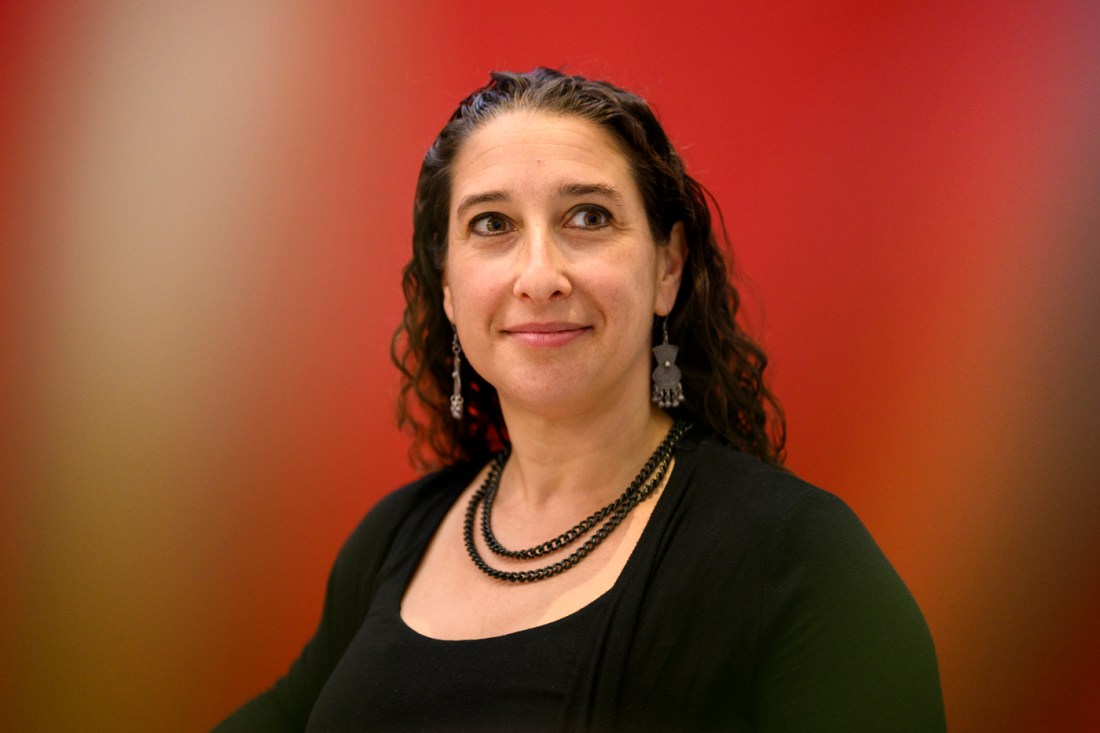 Zinaida Miller, a middle-aged white woman, smiles while looking off into the distance.
