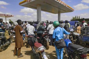 People queue with their motorcycles at a gas station amid a fuel shortage in Bamako Mali.